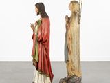 two statues of jesus and mary are standing next to each other