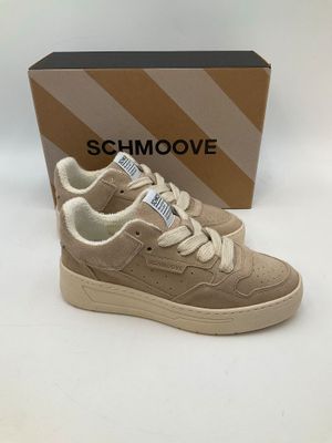 a pair of beige sneakers with white laces and a box on a white surface