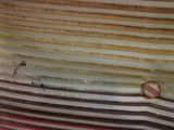 a striped shirt with a button on it