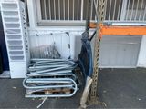a pile of luggage sitting on a pallet next to a building