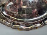 a silver tray with a mirror in it on a table