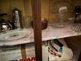 a shelf with dishes and dishes on it in the kitchen