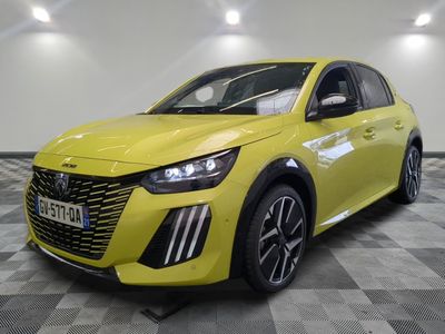 a yellow car is parked in a large room with a checkered floor