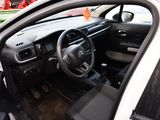 a car with a steering wheel and dashboard in a parking lot
