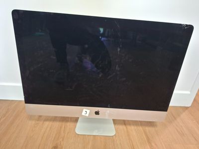 an apple computer monitor sitting on top of a wooden floor
