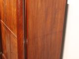 a dresser with a mirror on top of it in a room