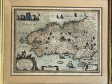 an old map of ireland in a gold frame on a wall