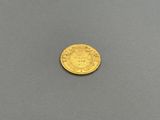 a gold coin on a gray surface