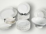 a lot of white plates and bowls on the table