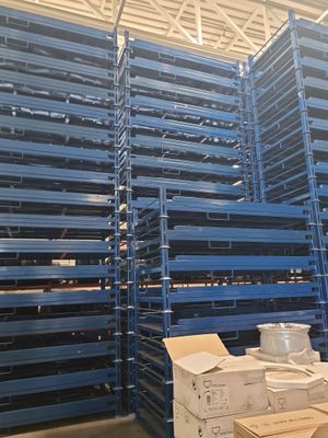 a large amount of pallets are stacked up in a warehouse