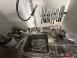 a kitchen sink with a lot of utensils in it