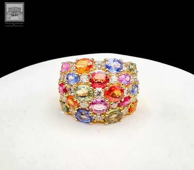 a ring with multi colored stones on a white plate