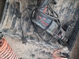 a box with a cord and a drill in it