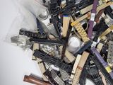 a pile of assorted toy guns on a white surface