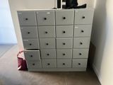 a cabinet that has a bunch of shoes on top of it