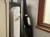 an image of a vacuum and a dryer in a small room