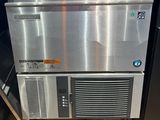 a stainless steel dishwasher and a refrigerator in a store