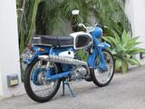 a blue motorcycle parked on the side of the road