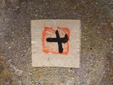 a piece of paper with a cross drawn on it