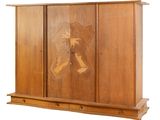a wooden cabinet with carvings on the front of it