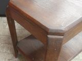 a small wooden table with a shelf on top of it