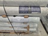 a stack of mattresses sitting on a pallet in a warehouse