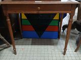 a small wooden desk with a drawer on top of it