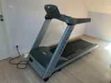 a treadmill in the corner of a room with a light on
