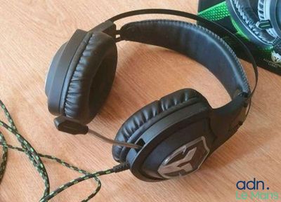 a pair of headphones sitting on a table next to a camera