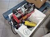 a box of tools sitting on the floor next to a cardboard box
