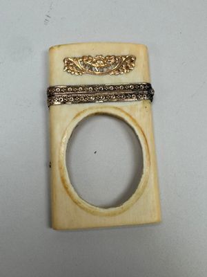 a small piece of ivory with a ring on top of it