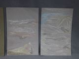 three pieces of paper that are on a table