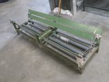 a green bench that is sitting in the middle of a room