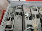 many pieces of metal in a box on the floor