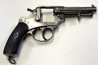 un pistolet posé sur une surface blanche