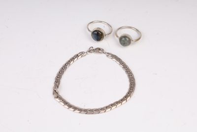Deux bagues et un bracelet sont posés sur une table
