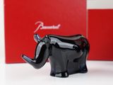 a black elephant figurine sitting in front of a red box