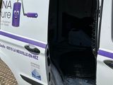 a van that has been vandalized and is parked on the side of the road