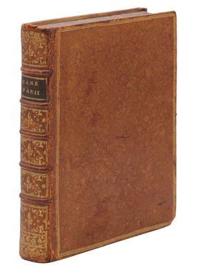un vieux livre à la couverture brune posé sur une surface blanche
