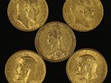 four gold sovereigns, one of which has a portrait of person and the other of which is a portrait