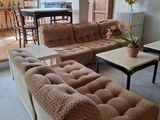 a living room with a couch, table, and chairs in it