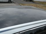 a silver car parked in front of a house