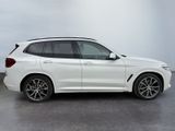 a white bmw suv parked in a parking lot
