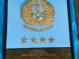 award plaque in a blue box with gold stars on it