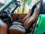 a green car with leather seats and a steering wheel