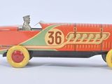 a red toy car with a man sitting in it
