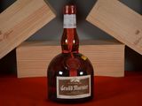 a bottle of wine sitting on a table next to two wooden boxes