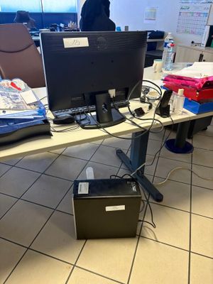 a desk with a computer monitor and a laptop on it