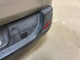 the rear bumper of a car with a number plate on it