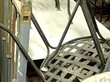 many chairs and tables that are outside in the sun